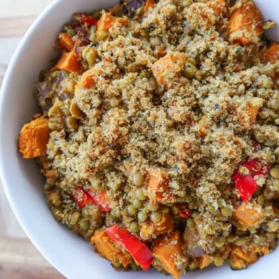 Fresh spinach and quinoa fill this Solstice Vegan Casserole served alongside sparkling citrus water.