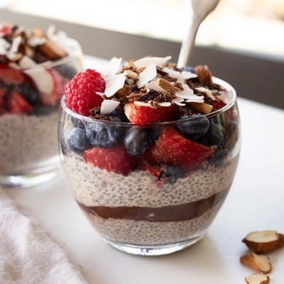 Rich chocolate coconut almond berry protein chia cream swirled with vibrant berries and crunchy roasted almond pieces