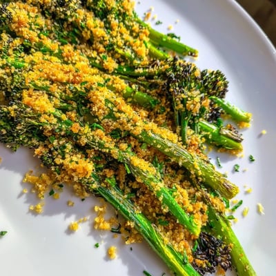 Golden breadcrumb topping over charred roasted broccolini with garlic herb crunch